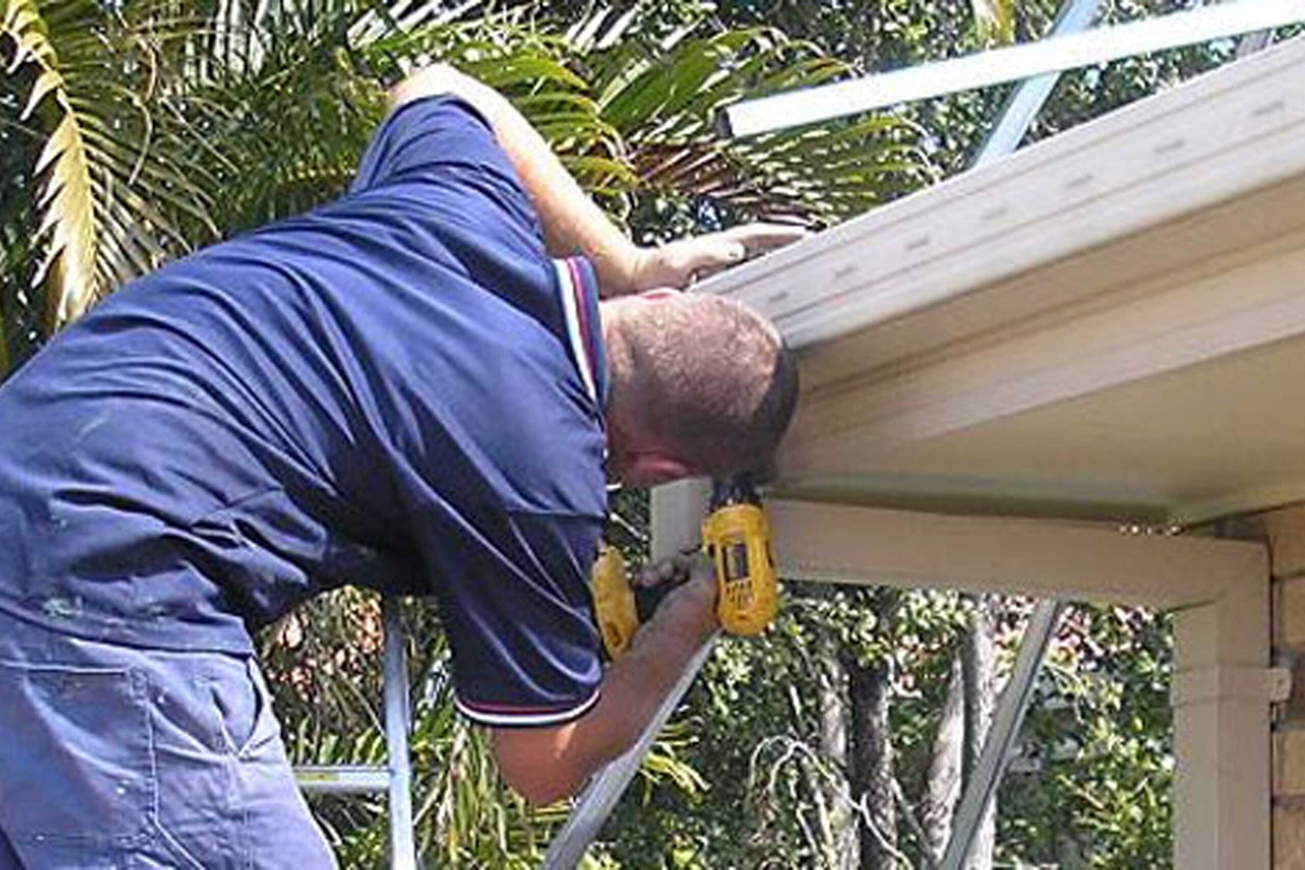 Man repairing gutter in Brisbane